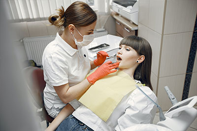 Dentist practicing over dental dummy
